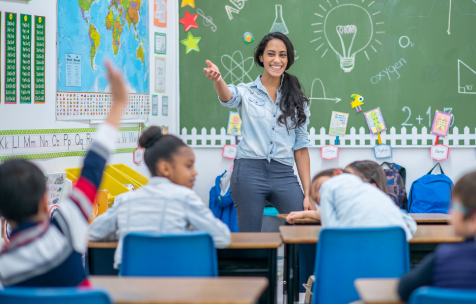 Picture of teacher with nice classroom decor