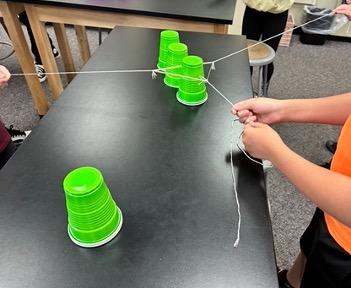 Cup stacking challenge, cup stacking, STEM activity, team building activity, cup stacking game with rubber bands, no hands cup stacking challenge instructions, cup stacking game rules, stacking cup game with timer,